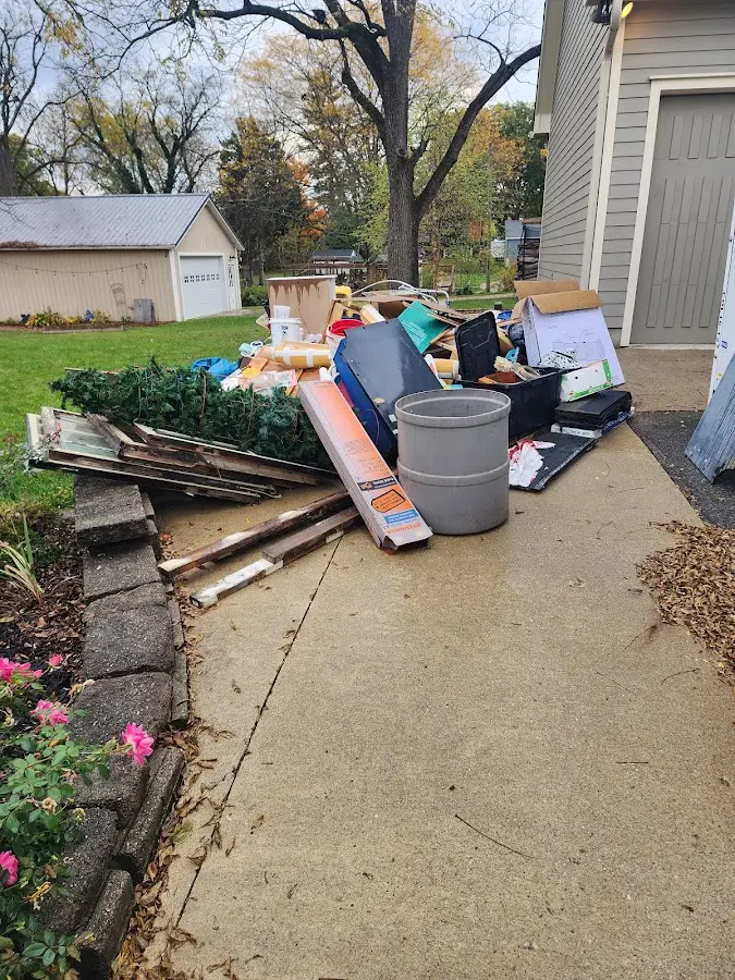 Dumpster being loaded with debris for 12 Yard Dumpster Rental in Limerick